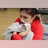 Jannett Martinez holds her cat Gigi as she rides a boat out of her neighborhood due to Tropical Storm Harvey in Houston, Tuesday