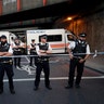 Police stand guard at a cordon on a road near Finsbury Park station after a vehicle struck pedestrians in north London
