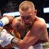 Floyd Mayweather Jr. punches Conor McGregor during their fight in Las Vegas