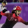 Samuel Girard of Canada celebrates at the finish line winning the gold medal in men's 1000 meters short track