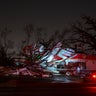 People stop to take a photo of a gas station damaged by an apparent tornado, Sunday, Jan. 22, 2017, in Albany, Ga.