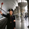 Pyongyang subway officer Ri Ok Gyong, 23, holds up a signal as she poses for a portrait in Pyongyang, North Korea, May 7, 2016
