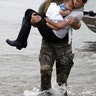 Houston Police SWAT officer Daryl Hudeck carries Catherine Pham and her 13-month-old son Aiden from flood waters in Houston, August 27