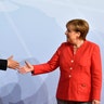 German Chancellor Angela Merkel greets China's President Xi Jinping at the start of the G-20 meeting in Hamburg, Germany