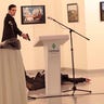 A gunman believed to be a Turkish special forces officer wields gun after shooting Russian Ambassador to Turkey Andrei Karlov Monday at a photo gallery in Ankara.