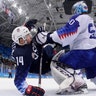 Goalie Jan Laco of Slovakia, pushes Broc Little of the United States during their men's ice hockey game at the 2018 Winter Olympics