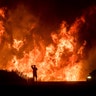 A motorist on Highway 101 watches flames from the Thomas fire north of Ventura, Calif., on Wednesday, Dec. 6, 2017