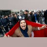 A_protester_with_a_Tunisian_flag_shouts_slogans
