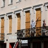 Derek Mundy and Kris Crouse board up the Confederate House in preparation for Hurricane Florence in Charleston, South Carolina, Tuesday