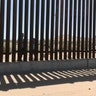 Mexican children look through the border fence into Santa Teresa, New Mexico