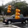 A motorist drives past fallen traffic lights in Wilmington, North Carolina, Friday