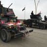 Armored car joins a parade celebrating the liberation of the eastern section of Mosul.
