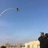 Iraqis shoot at an ISIS flag to celebrate after eastern Mosul is fully liberated. 