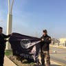 ISIS flag is used as a trophy to celebrate Iraq's takeover of eastern Mosul. 