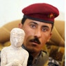 Iraqi Policeman Holding Artifact