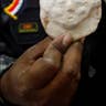 Iraqi Policeman Holding Artifact