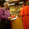Raniero Mancinelli shows a cardinal's skull cap in his tailor shop in Rome, Thursday Feb. 13, 2014.