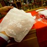Raniero Mancinelli holds a cheaper sample of lace material, left, as a more expensive hand-made one is seen on the counter, at his tailor shop in Rome, Thursday Feb. 13, 2014. 
