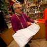 Raniero Mancinelli shows a cheaper sample of lace material in his tailor shop in Rome, Thursday Feb. 13, 2014. Mancinelli is putting the finishing touches on outfits commissioned by several of the new cardinals.