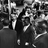 Martin Luther King Jr. encourages freedom riders as they board a bus for Jackson, Miss., 1961.