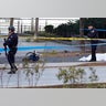Police officers stand next to a body covered under a white sheet near a mangled bike in New York City, October 31