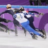 Nurbergen ZhNumagaziyev of Kazakhstan and Hongzhi Xu of China crash out during the 1500 meters short-track speedskating