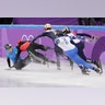 Nurbergen ZhNumagaziyev of Kazakhstan and Hongzhi Xu of China crash out during the 1500 meters short-track speedskating