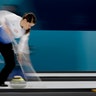 United States Becca Hamilton sweeps the ice during a mixed doubles curling match against Norway