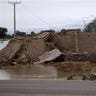 Villagers Gather by Collapsed House