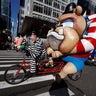 People dressed as cartoon characters on tandem bicycles during the Thanksgiving Day Parade