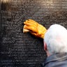 Vice President Mike Pence cleans the names of Vietnam vets at the Vietnam Veterans Memorial on Veterans Day.