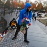 Volunteers remove mementos before cleaning the wall at the Vietnam Veterans Memorial on Veterans Day