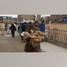 A man carries an injured boy