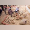 Egyptian excavation workers restore pottery near a new found in a tomb in Draa Abul Naga necropolis on Luxor's West Bank