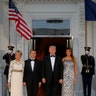 President Donald Trump, first lady Melania Trump, Brigitte Macron, and French President Emmanuel Macron walk down the Grand Staircase 
