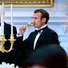 President Donald Trump and French President Emmanuel Macron toast in the State Dining Room