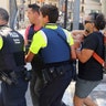 An injured person is carried after a van crashed into a summer crowd of residents and tourists on Las Ramblas in Barcelona, August 17