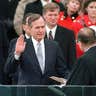 President George H. W. Bush raises his hand as he takes the oath of office as President of the United States outside the Capitol on Jan. 20, 1989, Washington, D.C. 