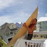 Tim Avery pulls boards to the third story of a home as he prepares for Hurricane Florence in Emerald Isle North Carolina, Wednesday