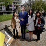 Tourists have their photo taken with cardboard cutouts of Britain's Prince Harry and his fiancee Meghan Markle, in London, May 3, 2018