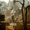 Bree Laubacher pauses while sifting through rubble at her Ventura, Calif., home following a wildfire, Wednesday