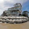 Sand bags surround homes on North Topsail Beach, North Carolina, Wednesday