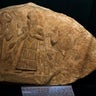 A limestone slab showing the water god, Ea, receiving a minor deity