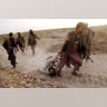 Soldier being dragged along the ground by a fighter