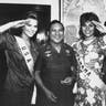 Miss USA, Christy Fichtner, and Miss Panama, Gilda Garcia Lopez, salute while flanking General Noriega in Panama City on July 5, 1986.