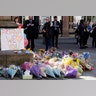 Floral tributes are seen in Manchester, England, the day after the suicide attack at an Ariana Grande concert
