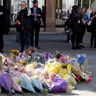 Floral tributes are seen in Manchester, England, the day after the suicide attack at an Ariana Grande concert