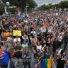 Marchers gather to hear speakers at the end of the Los Angeles LGBTQ #ResistMarch, in West Hollywood, California