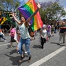 A marcher mugs for the camera during the Los Angeles LGBTQ #ResistMarch, in West Hollywood, California