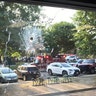 Emergency personnel are seen through a window with a bullet hole in Alexandria, Va., Wednesday